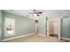 Bright bedroom featuring neutral walls, carpeted floors, a ceiling fan, and a bathroom ensuite at 950 Sw 43Rd Pl, Ocala, FL 34471