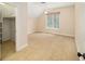 A carpeted bedroom features a window with blinds, a ceiling fan, and a closet area at 950 Sw 43Rd Pl, Ocala, FL 34471