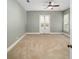 Spacious bedroom with neutral walls, carpeted floors, double french doors and plenty of natural light at 950 Sw 43Rd Pl, Ocala, FL 34471