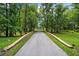 Picturesque driveway lined with mature trees, creating a grand entrance to the property at 950 Sw 43Rd Pl, Ocala, FL 34471
