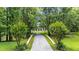 Long driveway leading to the home, surrounded by lush greenery and mature trees at 950 Sw 43Rd Pl, Ocala, FL 34471