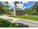 Stately two-story home with a welcoming front porch and lush landscaping, exuding charm and curb appeal at 950 Sw 43Rd Pl, Ocala, FL 34471