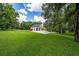 Exterior view of the garage and lush lawn at 950 Sw 43Rd Pl, Ocala, FL 34471