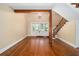 Open foyer with hardwood floors, staircase, and a chandelier hanging above the entryway at 950 Sw 43Rd Pl, Ocala, FL 34471