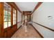 Entry Foyer features wooden door, wood trim, tile flooring, and a spiral staircase at 950 Sw 43Rd Pl, Ocala, FL 34471