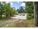 View of the property's parking pad and work area with ample room for tractors and equipment at 950 Sw 43Rd Pl, Ocala, FL 34471