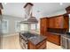 Open kitchen with stainless steel range, custom cabinetry, granite countertops, and tile flooring at 950 Sw 43Rd Pl, Ocala, FL 34471