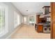 Bright eat-in kitchen with stainless steel appliances, ample windows, and tan tile flooring at 950 Sw 43Rd Pl, Ocala, FL 34471