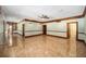 Bright living area with glossy tile flooring, wood trim, and a ceiling fan at 950 Sw 43Rd Pl, Ocala, FL 34471