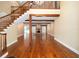 Open-concept living space features hardwood floors, a staircase, and exposed wood beams at 950 Sw 43Rd Pl, Ocala, FL 34471