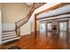 Grand living room with hardwood floors, a striking fireplace, an open staircase, and natural light at 950 Sw 43Rd Pl, Ocala, FL 34471