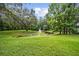 Serene pond with a fountain feature, surrounded by lush greenery, offering a tranquil escape at 950 Sw 43Rd Pl, Ocala, FL 34471