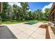 Backyard swimming pool features tile patio and landscaping at 950 Sw 43Rd Pl, Ocala, FL 34471