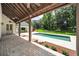 Backyard pool with a covered patio and landscaping at 950 Sw 43Rd Pl, Ocala, FL 34471