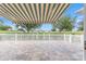 Paver patio is partially covered by retractable awning, and overlooks the manicured golf course at 9693 Sw 90Th St, Ocala, FL 34481