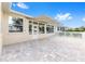 Relax on this spacious paver patio, featuring a retractable awning and views of the sunroom at 9693 Sw 90Th St, Ocala, FL 34481