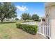 A well-manicured backyard features a white picket fence and golf course views at 9693 Sw 90Th St, Ocala, FL 34481