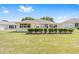 A well-manicured backyard is enclosed by a white picket fence with a well maintained lawn at 9693 Sw 90Th St, Ocala, FL 34481