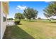 A well-maintained lawn with a golf course, trees and shrubbery in the background at 9693 Sw 90Th St, Ocala, FL 34481