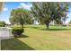 A green manicured lawn with golf course views and mature trees in the background at 9693 Sw 90Th St, Ocala, FL 34481