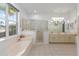 Bright bathroom featuring a soaking tub, shower, and double sinks at 9693 Sw 90Th St, Ocala, FL 34481