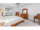 Bright bedroom featuring a ceiling fan and view into the backyard at 9693 Sw 90Th St, Ocala, FL 34481