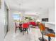Eat-in breakfast nook with bright windows and a modern light fixture looks out to a manicured lawn at 9693 Sw 90Th St, Ocala, FL 34481