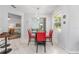 Dining area with table, chairs, and modern light fixture is open to the living room at 9693 Sw 90Th St, Ocala, FL 34481