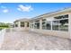 The home's rear exterior is complimented by a paver patio and retractable awning for outdoor enjoyment at 9693 Sw 90Th St, Ocala, FL 34481