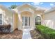 Inviting front entrance with decorative glass double doors and well-maintained landscaping at 9693 Sw 90Th St, Ocala, FL 34481