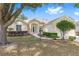 Charming single story home with manicured lawn and front door with decorative glass panes at 9693 Sw 90Th St, Ocala, FL 34481