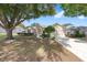 Charming single story home boasts a manicured lawn, lovely landscaping, and a concrete driveway at 9693 Sw 90Th St, Ocala, FL 34481