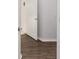 Hallway featuring wood floors and open door at 9693 Sw 90Th St, Ocala, FL 34481