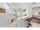 Bright kitchen boasting white cabinets, a bar with seating, and modern appliances at 9693 Sw 90Th St, Ocala, FL 34481