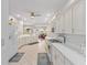 Bright, white kitchen features modern appliances and ample counter space, opening to the living area at 9693 Sw 90Th St, Ocala, FL 34481