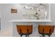 Kitchen showcasing white cabinetry, a bar, and pendant lighting above seating at 9693 Sw 90Th St, Ocala, FL 34481