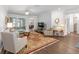Open living area featuring hardwood floors, comfortable seating, and access to the patio at 9693 Sw 90Th St, Ocala, FL 34481