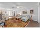 Bright living room featuring a ceiling fan and large rug at 9693 Sw 90Th St, Ocala, FL 34481