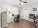 A home office setup with wood floors, dual monitors, and comfortable chairs at 9693 Sw 90Th St, Ocala, FL 34481