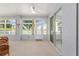 Enclosed sunroom with multiple windows, comfortable seating, and a view of the fenced backyard at 9693 Sw 90Th St, Ocala, FL 34481