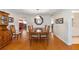 Well-lit dining room with a large wooden table, seating for four, and hardwood floors at 9726 Sw 94Th Ter # C, Ocala, FL 34481