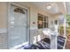 Inviting front porch with a white wicker chair and view of the front yard at 9726 Sw 94Th Ter # C, Ocala, FL 34481