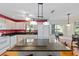 Open kitchen boasts a large island with seating, white appliances, and views of the backyard at 9726 Sw 94Th Ter # C, Ocala, FL 34481
