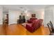 Cozy living room with hardwood floors, a ceiling fan, and adjacent dining and kitchen areas at 9726 Sw 94Th Ter # C, Ocala, FL 34481
