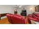 Comfortable living room with hardwood floors, media center, and two reclining sofas at 9726 Sw 94Th Ter # C, Ocala, FL 34481