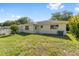 A well-maintained backyard with green grass, a white fence, and an air conditioning unit at 9758 Sw 94Th Ave # A, Ocala, FL 34481