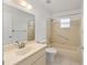 Bathroom with single vanity, neutral tile surround, walk-in shower, and window at 9758 Sw 94Th Ave # A, Ocala, FL 34481