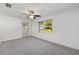 Spacious bedroom featuring carpet, a window with green outdoors view and white trim at 9758 Sw 94Th Ave # A, Ocala, FL 34481