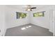 Bright bedroom with carpet, ceiling fan, two windows allowing light into the room and closet at 9758 Sw 94Th Ave # A, Ocala, FL 34481