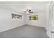 A well-lit room with carpet, ceiling fan, two windows with wooded views, and a closet at 9758 Sw 94Th Ave # A, Ocala, FL 34481